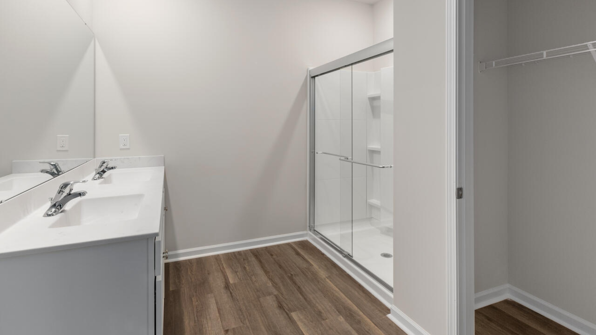 The Primary Suite offers a massive closet and a luxurious bathroom with a walk-in shower, linen closet, and dual vanity.
