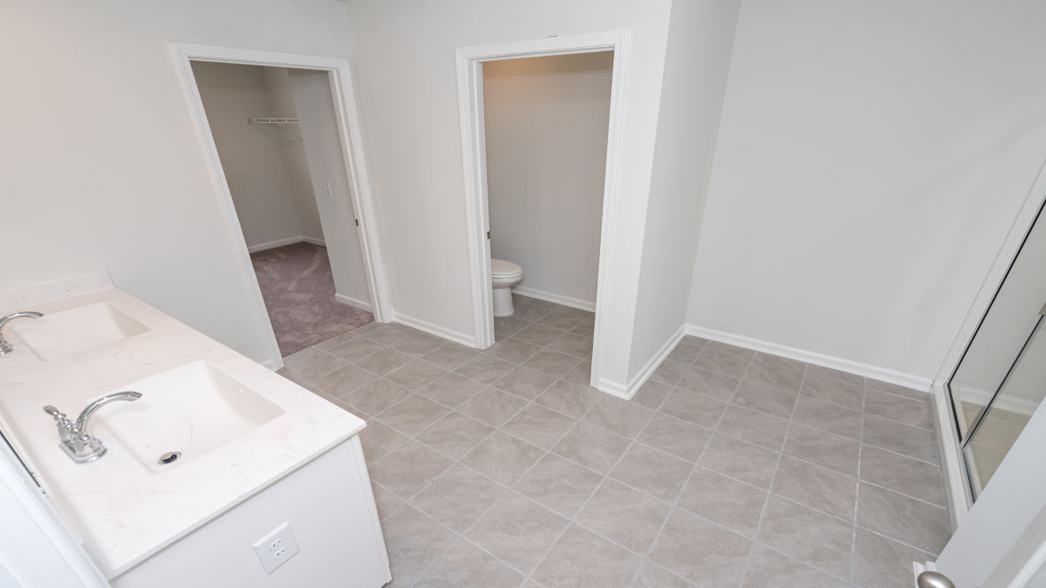 The primary bedroom is a perfect retreat with a walk-in closet and generous primary bathroom featuring a double vanity, large shower, and a separate linen closet