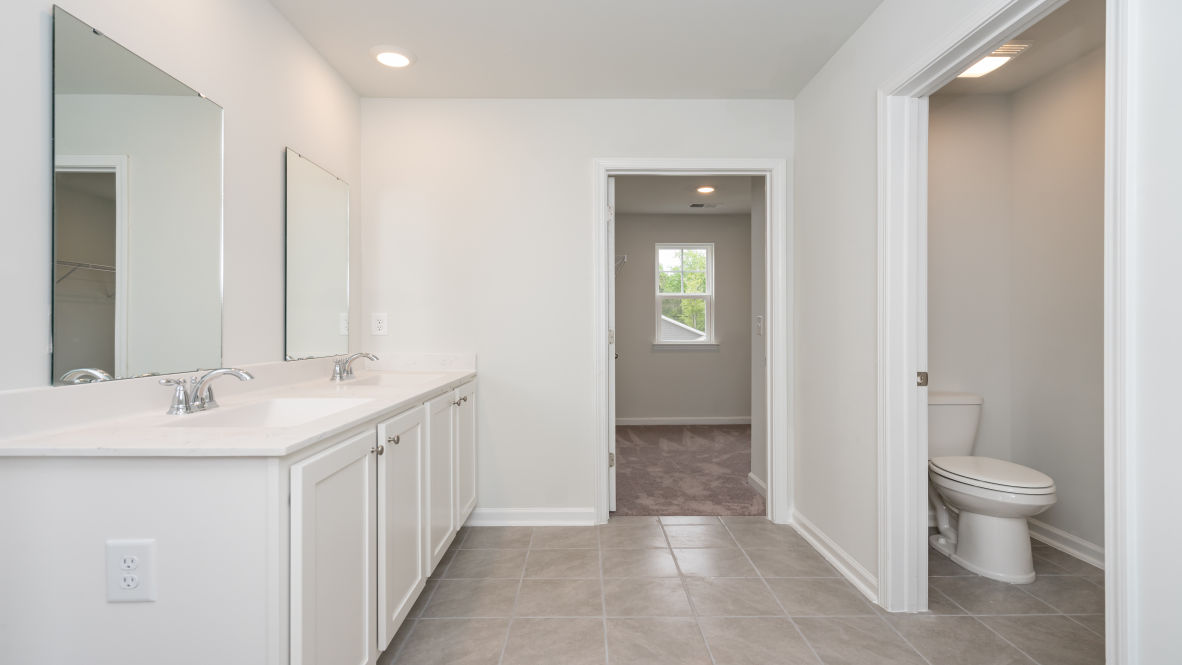 The primary bedroom is a perfect retreat with a walk-in closet and generous primary bathroom featuring a double vanity, large shower, and a separate linen closet