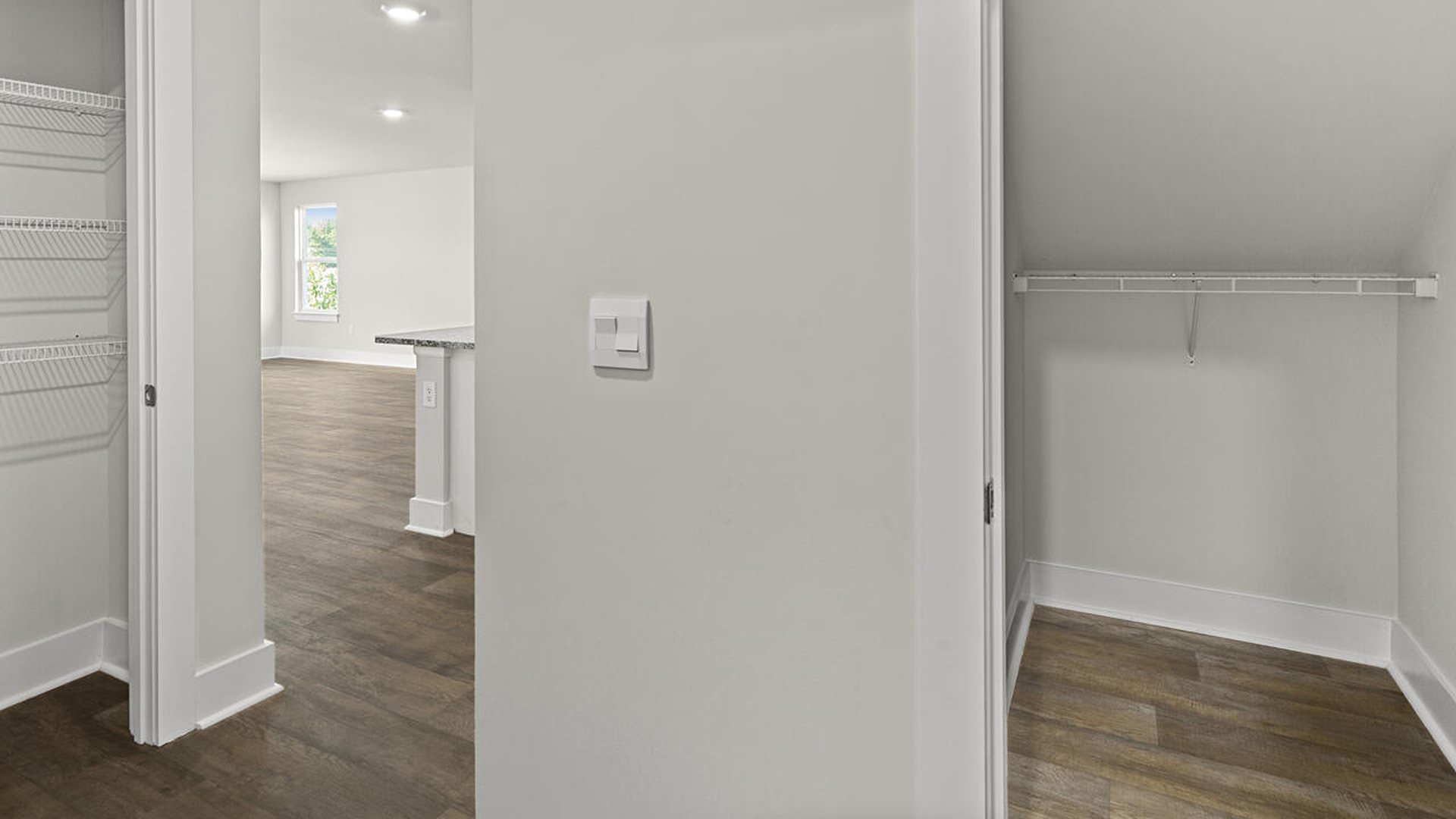 This beautiful kitchen features white cabinetry, granite counters, a large kitchen island with room for 4 counter height barstools and there's a pantry too. You’ll never be too far from the action with the living and dining area right there.