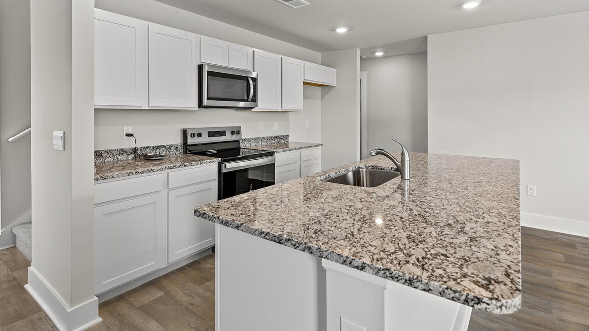 Entering the great room, we find the dining area, family room and a wonderful cook's kitchen are all together for open living.