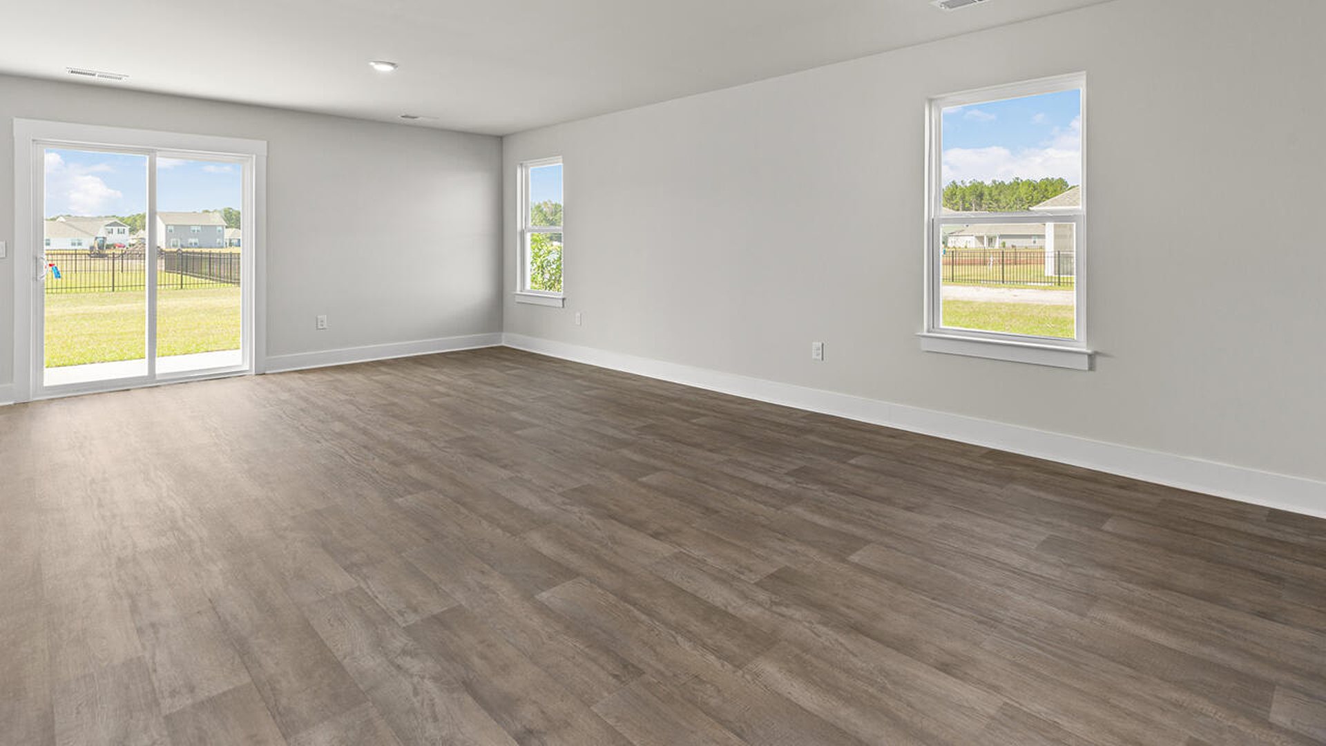 Entering the great room, we find the dining area, family room and a wonderful cook's kitchen are all together for open living.