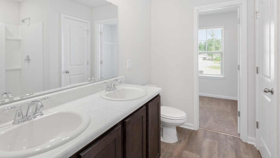 The primary bedroom has its own attached bathroom that features a walk-in closet and all the space you need to get ready in the morning.