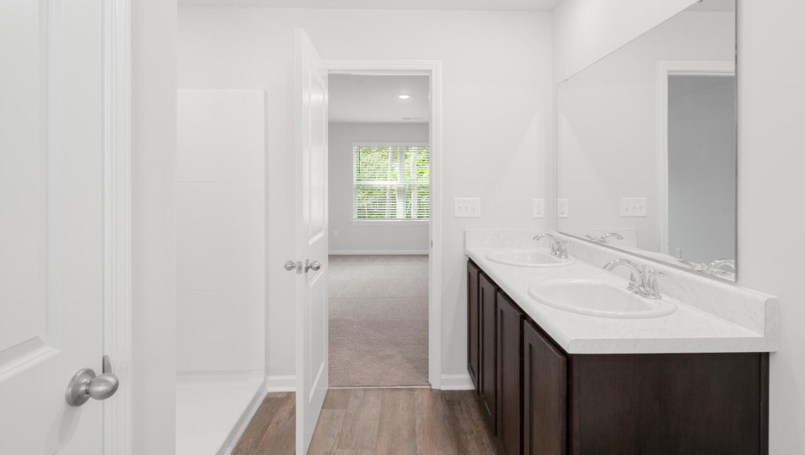 The primary bedroom has its own attached bathroom that features a walk-in closet and all the space you need to get ready in the morning.