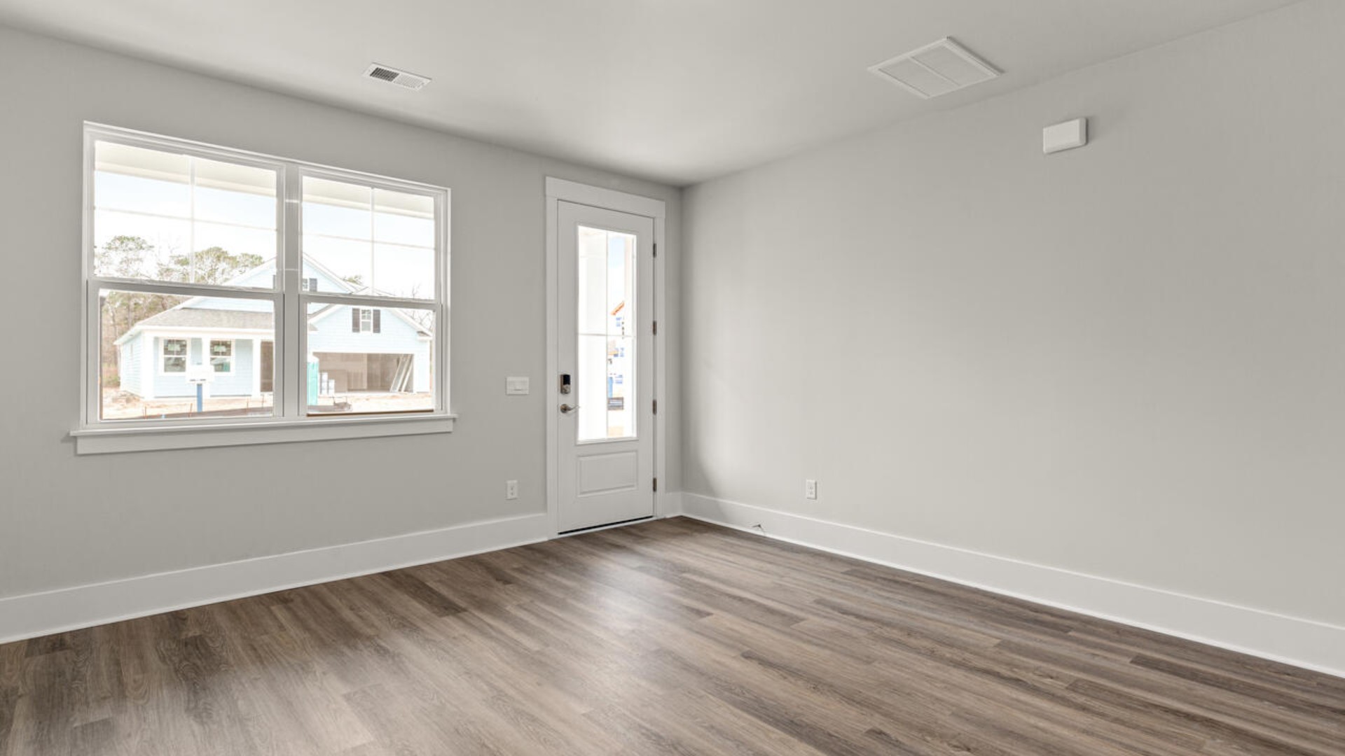 Entering the home, we find a large family room and dining area that's perfect for entertaining.