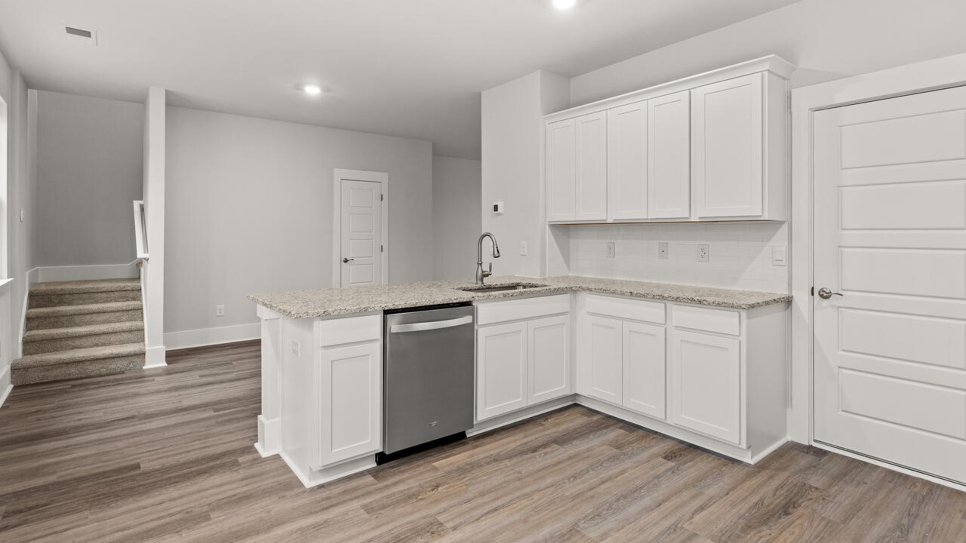 he heart of the home is the kitchen granite counters, a large peninsula island with room for 4 counter height barstools. The stainless-steel appliances, microwave, dishwasher and single bowl sink.