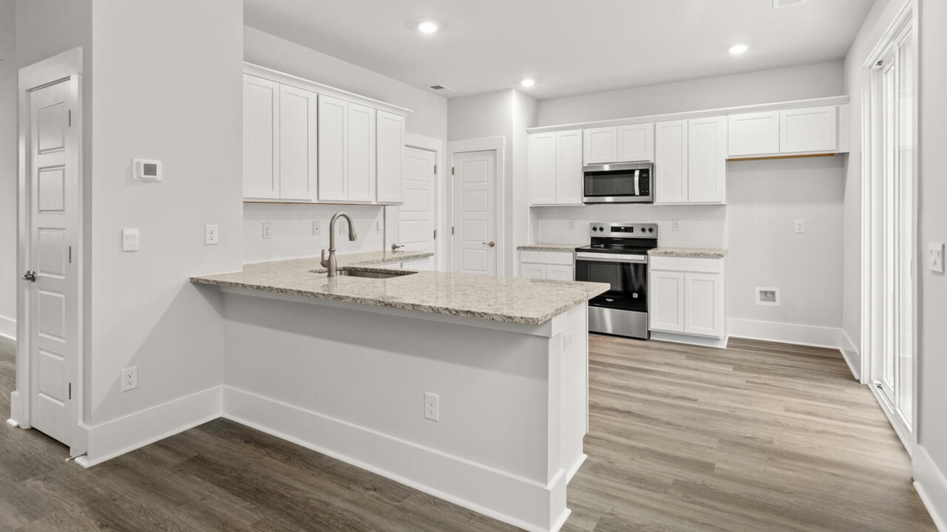 Entering the home we find a large family room and dining area that's perfect for entertaining. The heart of the home is the kitchen granite counters, a large peninsula island with room for 4 counter height barstools. T