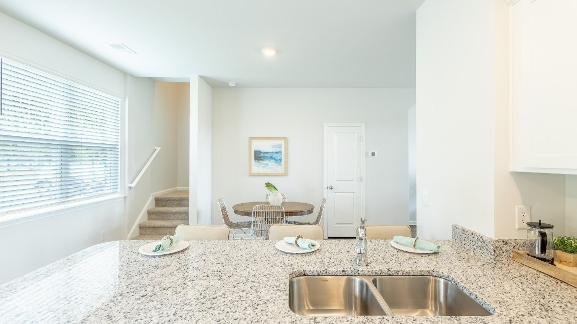 Entering the home we find a large family room and dining area that's perfect for entertaining. The heart of the home is the kitchen granite counters, a large peninsula island with room for 4 counter height barstools. The stainless-steel Whirlpool appliances include a 5-burner gas range, microwave, dishwasher, single-bowl sink and even a refrigerator!