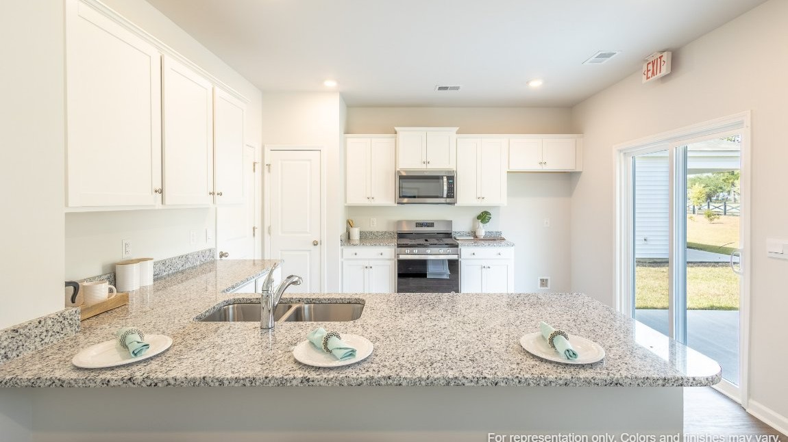 Entering the home we find a large family room and dining area that's perfect for entertaining. The heart of the home is the kitchen granite counters, a large peninsula island with room for 4 counter height barstools. The stainless-steel Whirlpool appliances include a 5-burner gas range, microwave, dishwasher, single-bowl sink and even a refrigerator!