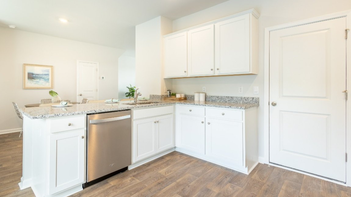 Entering the home we find a large family room and dining area that's perfect for entertaining. The heart of the home is the kitchen granite counters, a large peninsula island with room for 4 counter height barstools. The stainless-steel Whirlpool appliances include a 5-burner gas range, microwave, dishwasher, single-bowl sink and even a refrigerator!