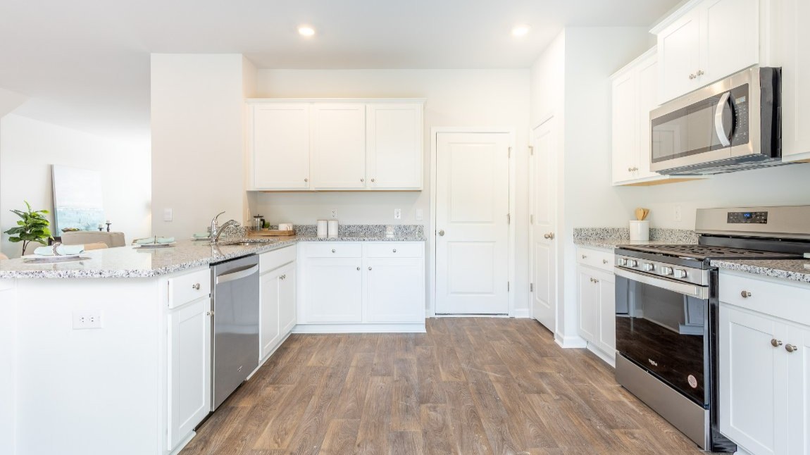 Entering the home we find a large family room and dining area that's perfect for entertaining. The heart of the home is the kitchen granite counters, a large peninsula island with room for 4 counter height barstools. The stainless-steel Whirlpool appliances include a 5-burner gas range, microwave, dishwasher, single-bowl sink and even a refrigerator!