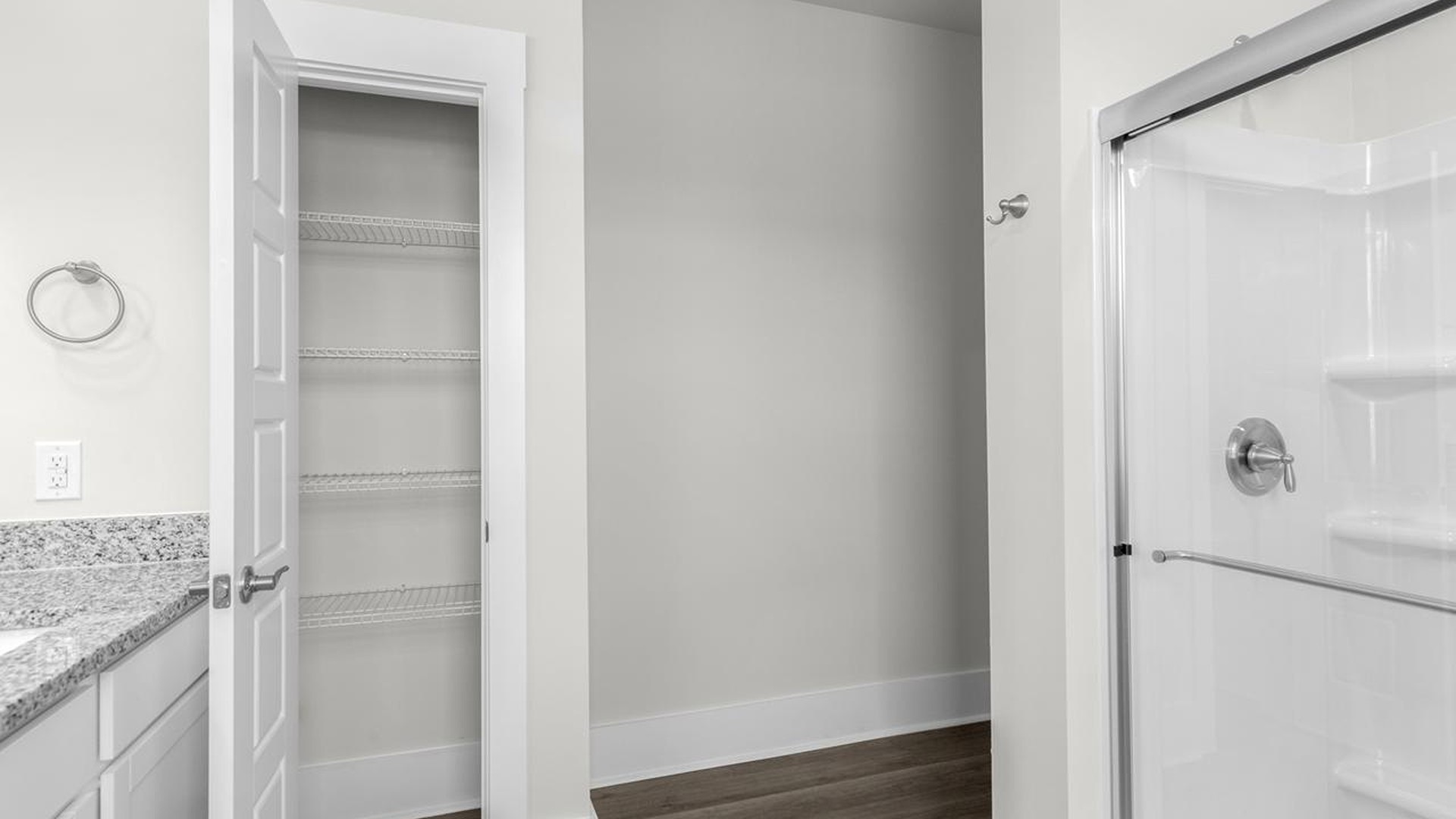The downstairs primary suite includes a walk-in-closet and ensuite bath with a double vanity, walk-in-shower, and separate water closet. The guest ensuite upstairs provides tons of privacy and LVP flooring throughout the main level makes cleanups a breeze
