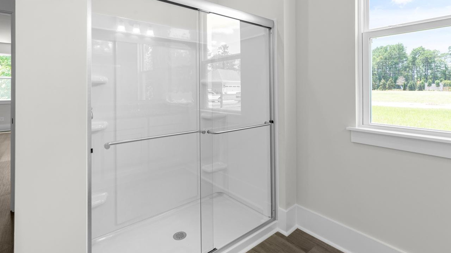 The downstairs primary suite includes a walk-in-closet and ensuite bath with a double vanity, walk-in-shower, and separate water closet. The guest ensuite upstairs provides tons of privacy and LVP flooring throughout the main level makes cleanups a breeze