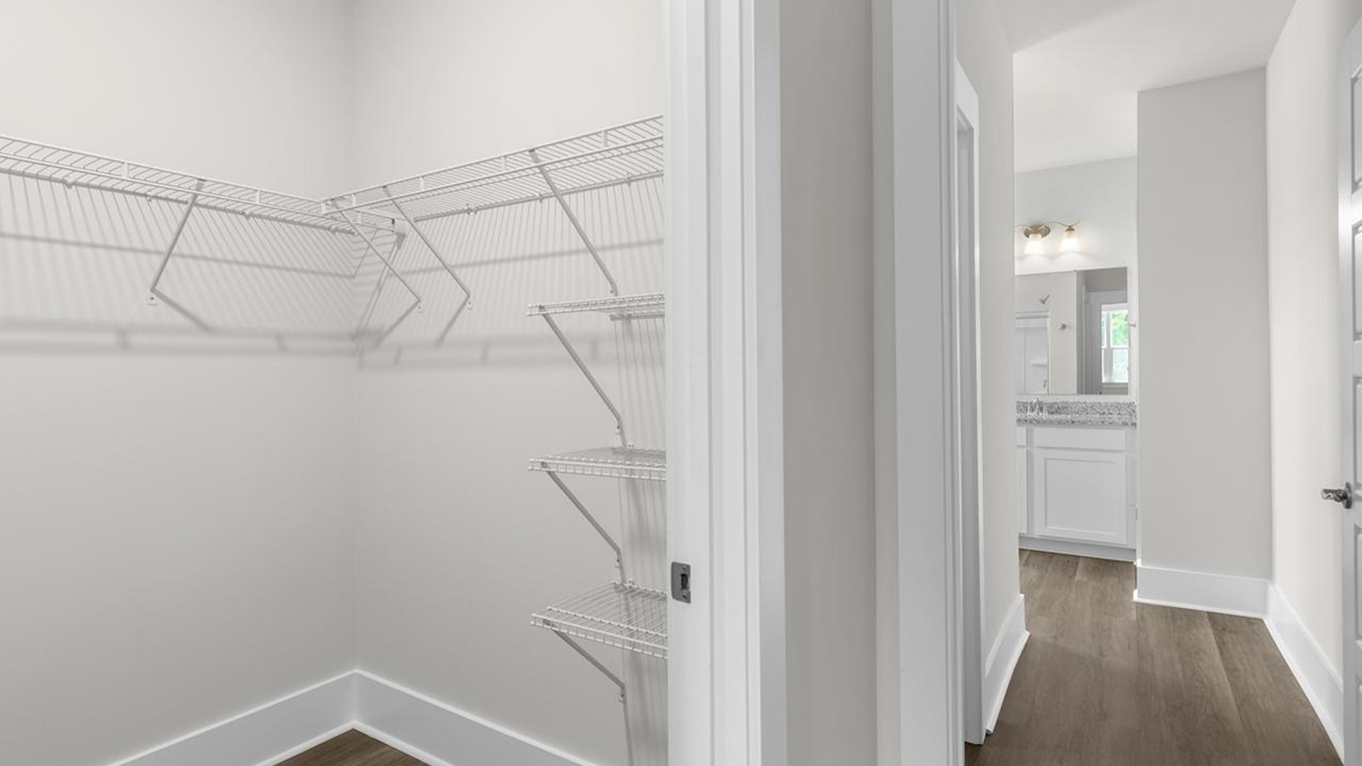 The downstairs primary suite includes a walk-in-closet and ensuite bath with a double vanity, walk-in-shower, and separate water closet. The guest ensuite upstairs provides tons of privacy and LVP flooring throughout the main level makes cleanups a breeze