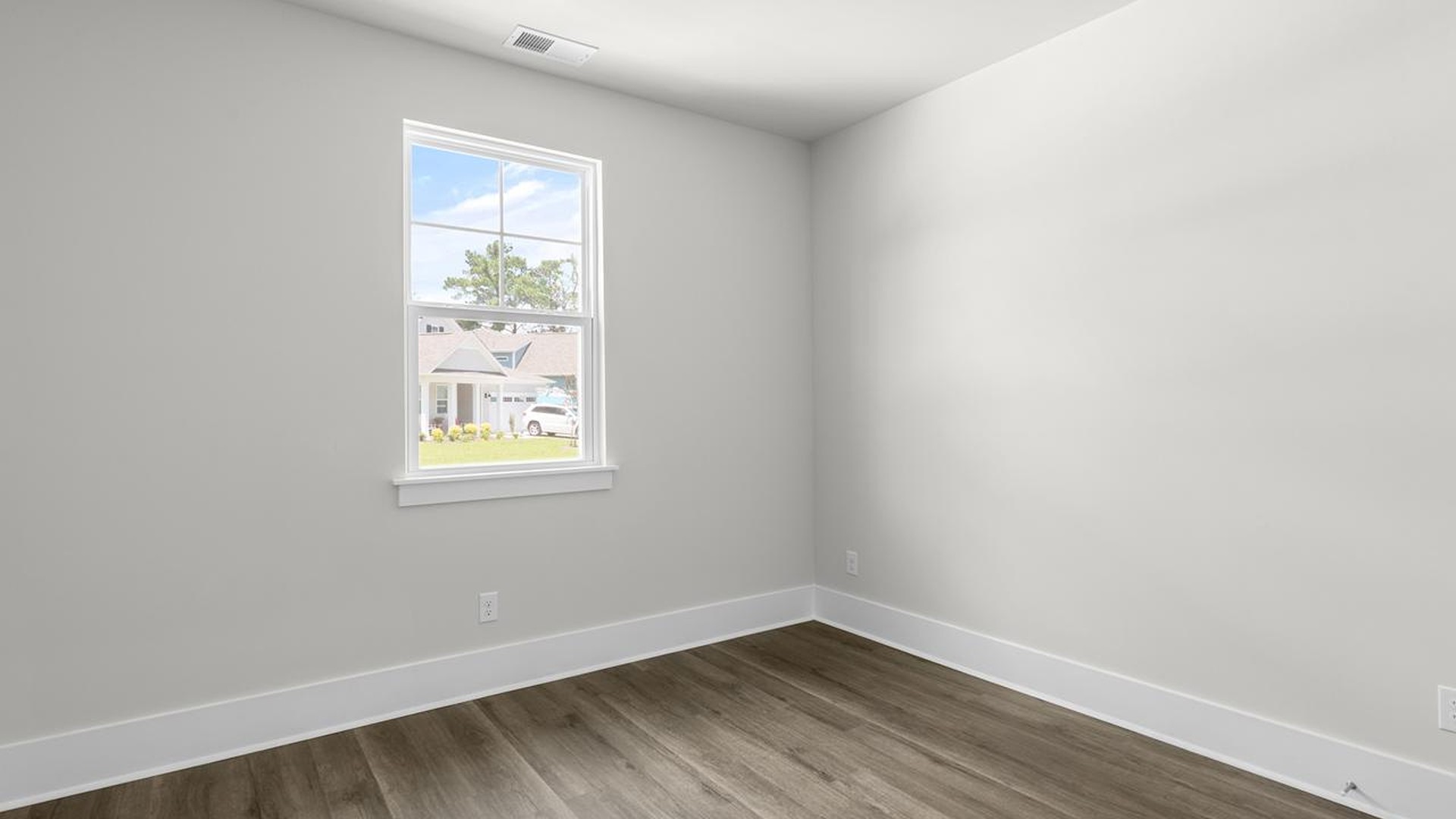 As you make your way off the front porch, a foyer leads you into the heart of the home. Two bedrooms sit off the main foyer and share a full bathroom in the middle