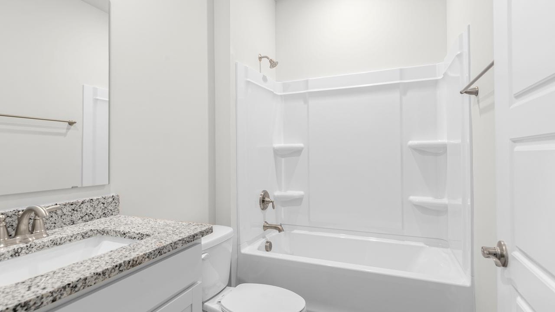 As you make your way off the front porch, a foyer leads you into the heart of the home. Two bedrooms sit off the main foyer and share a full bathroom in the middle