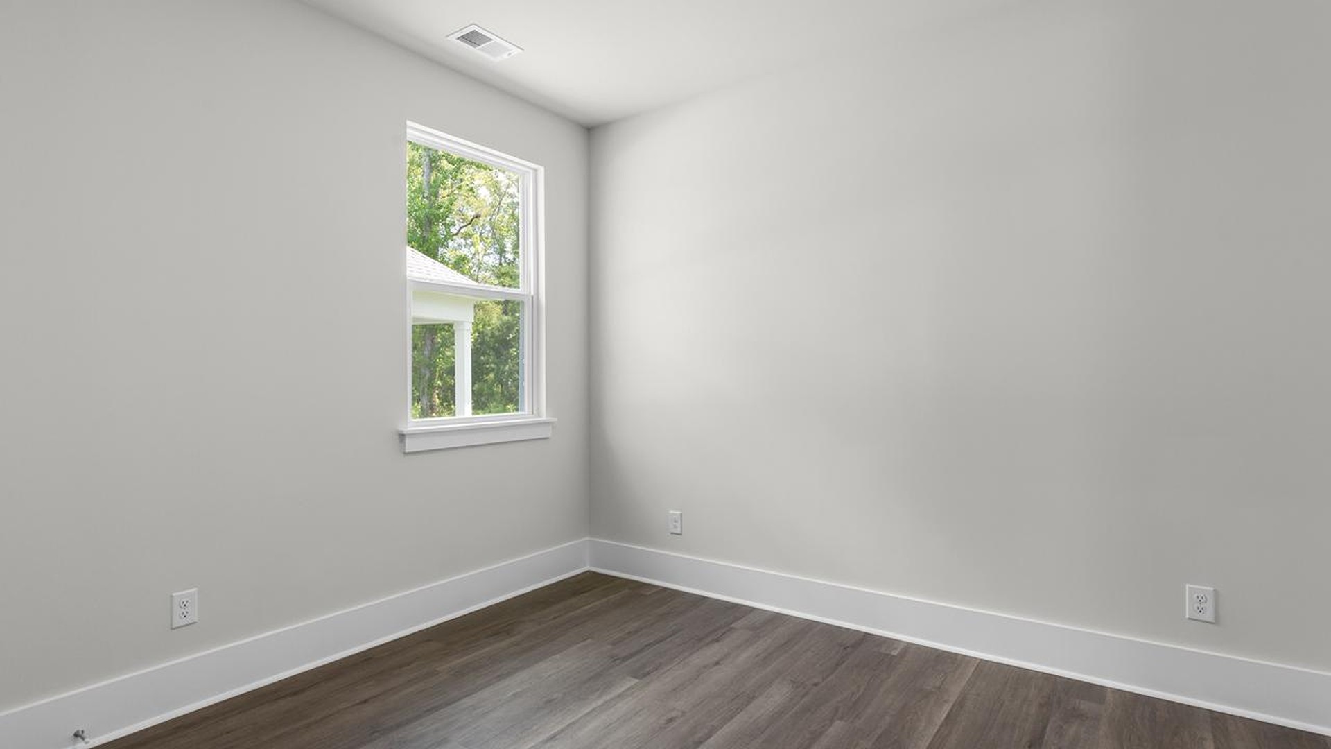 As you make your way off the front porch, a foyer leads you into the heart of the home. Two bedrooms sit off the main foyer and share a full bathroom in the middle