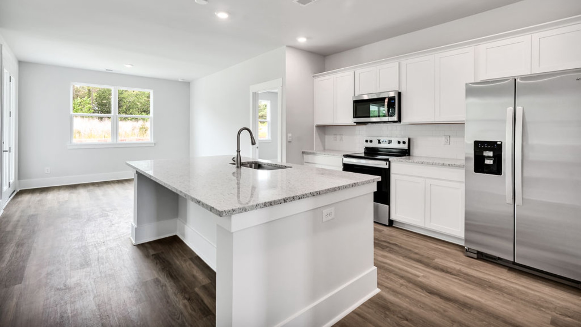 The main living area does not disappoint, by offering plenty of room to gather with family and friends. The kitchen includes a walk-in pantry, stainless-steel appliances, and a large island for bar seating.