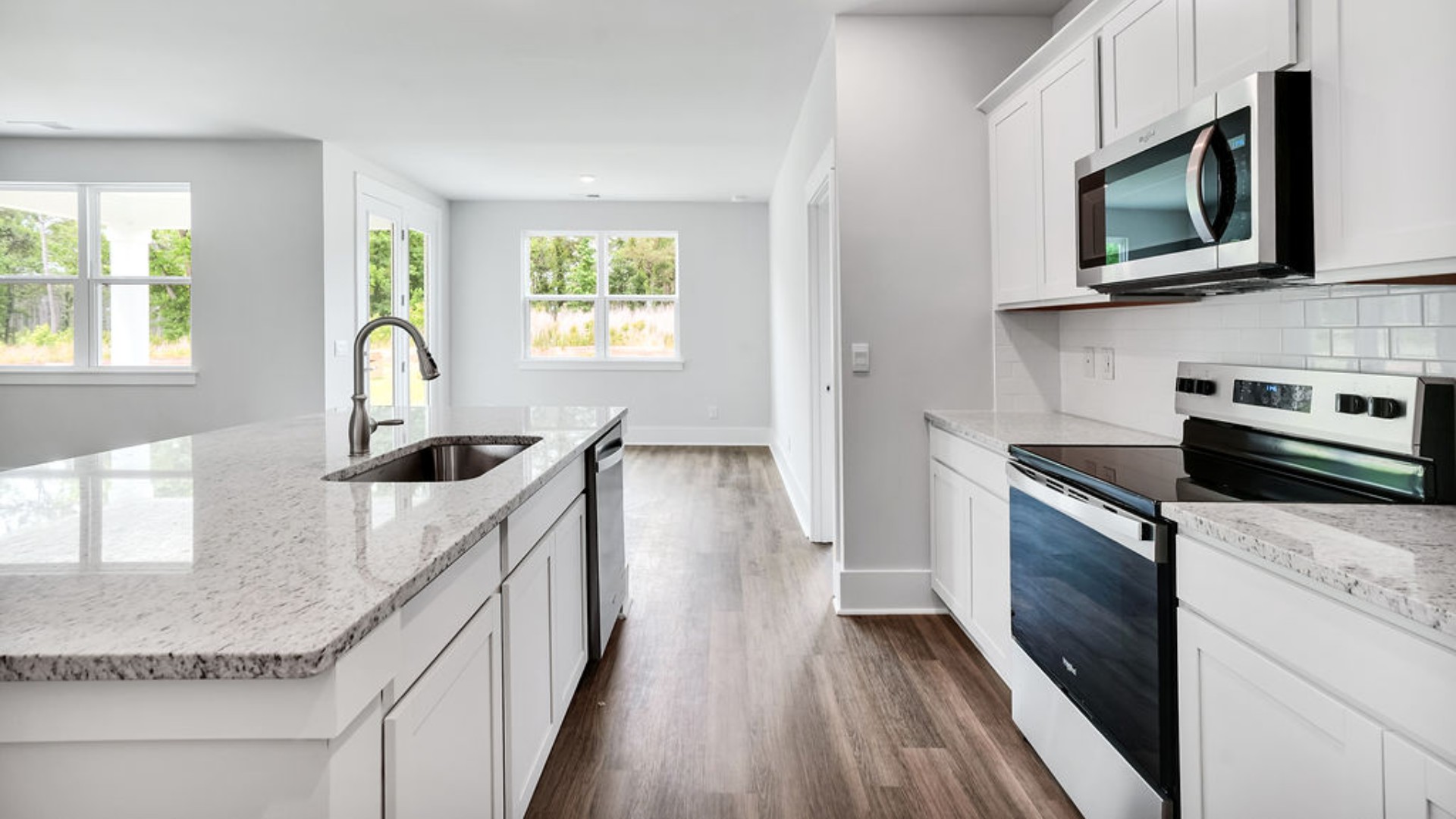 The main living area does not disappoint, by offering plenty of room to gather with family and friends. The kitchen includes a walk-in pantry, stainless-steel appliances, and a large island for bar seating.
