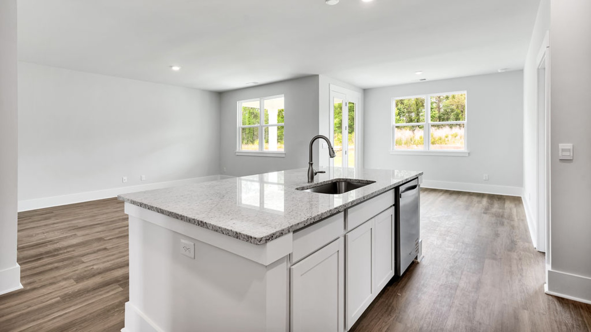 The main living area does not disappoint, by offering plenty of room to gather with family and friends. The kitchen includes a walk-in pantry, stainless-steel appliances, and a large island for bar seating.