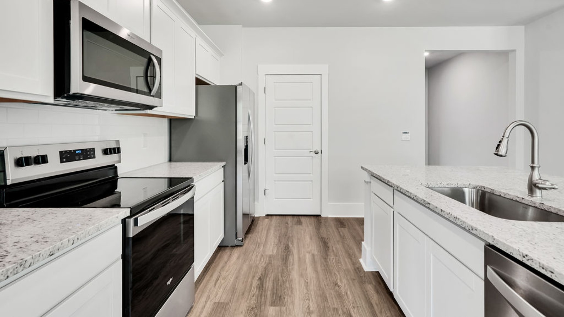 The main living area does not disappoint, by offering plenty of room to gather with family and friends. The kitchen includes a walk-in pantry, stainless-steel appliances, and a large island for bar seating.