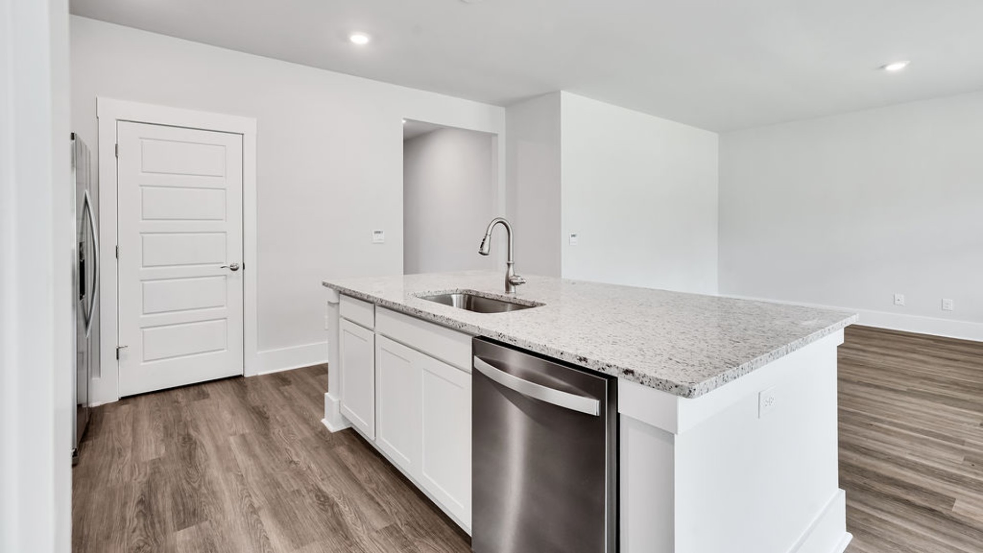 The main living area does not disappoint, by offering plenty of room to gather with family and friends. The kitchen includes a walk-in pantry, stainless-steel appliances, and a large island for bar seating.
