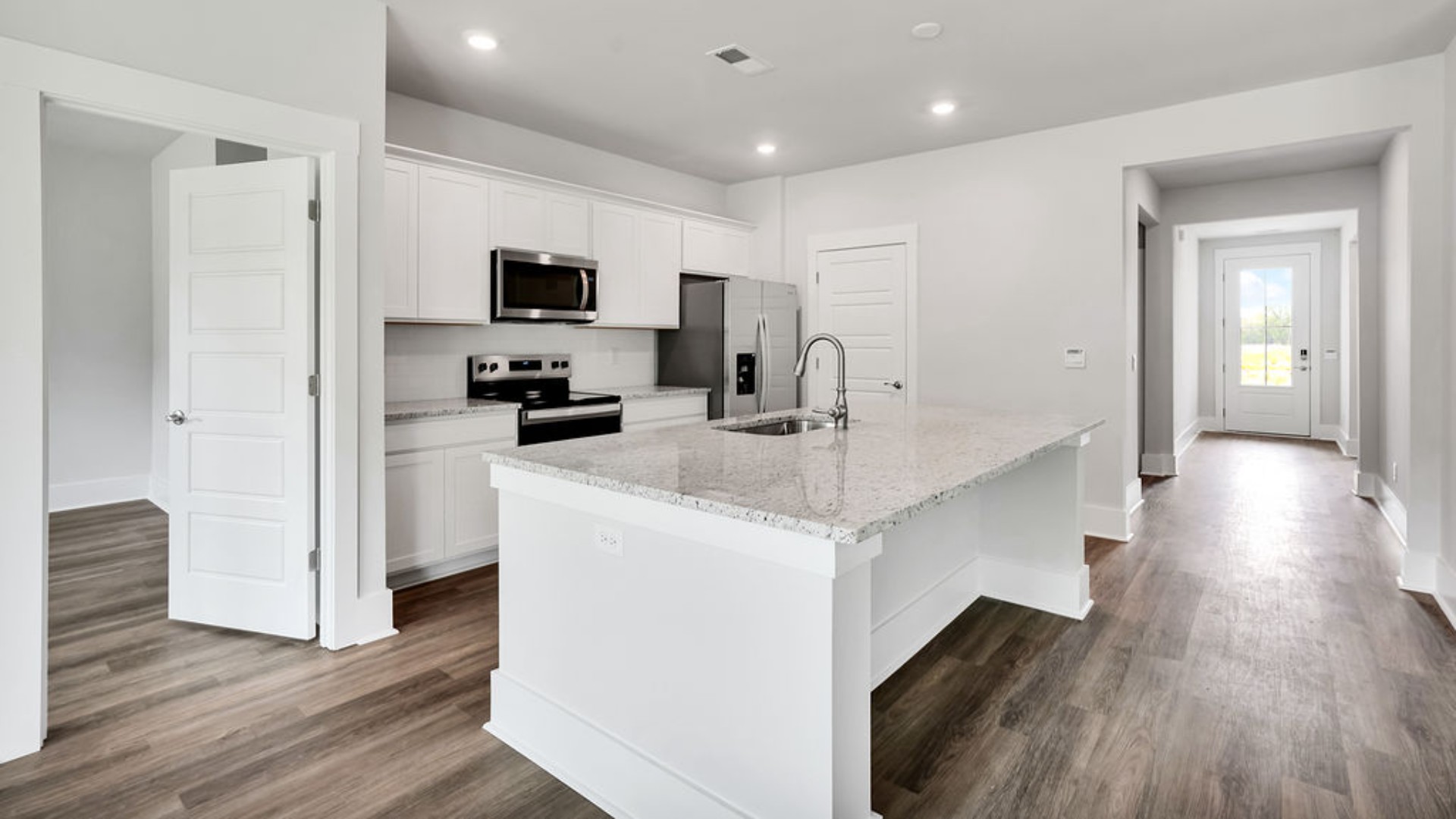 The main living area does not disappoint, by offering plenty of room to gather with family and friends. The kitchen includes a walk-in pantry, stainless-steel appliances, and a large island for bar seating.