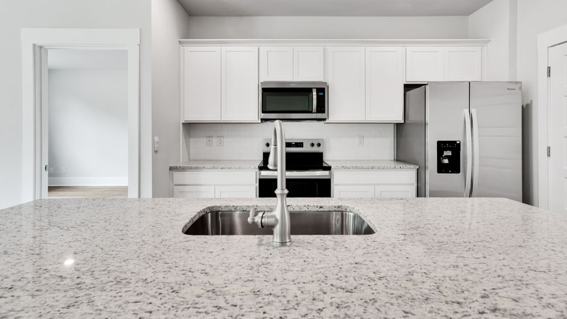 The main living area does not disappoint, by offering plenty of room to gather with family and friends. The kitchen includes a walk-in pantry, stainless-steel appliances, and a large island for bar seating.