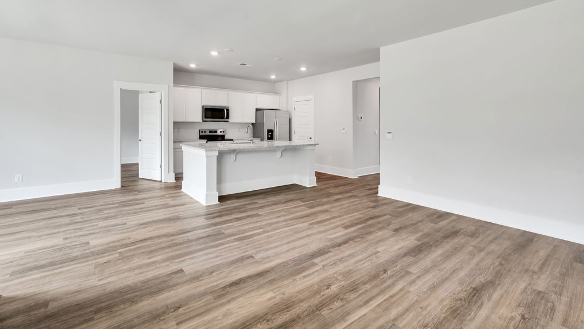 The main living area does not disappoint, by offering plenty of room to gather with family and friends. The kitchen includes a walk-in pantry, stainless-steel appliances, and a large island for bar seating.