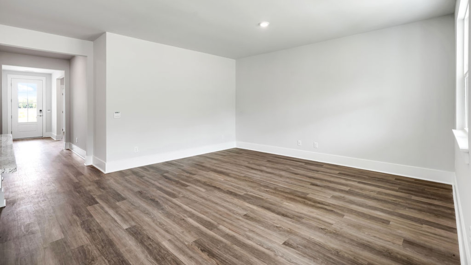 The main living area does not disappoint, by offering plenty of room to gather with family and friends. The kitchen includes a walk-in pantry, stainless-steel appliances, and a large island for bar seating.