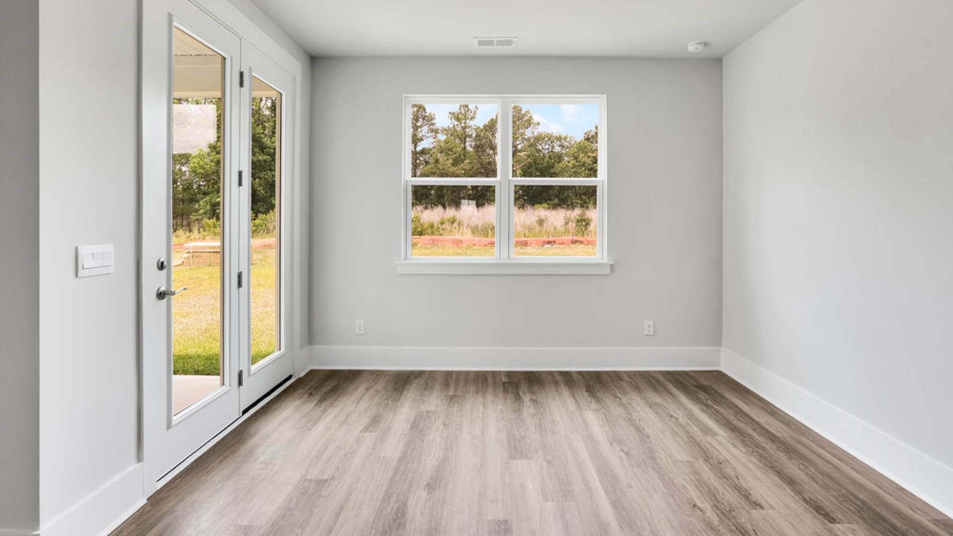 The primary suite is tucked away in the back corner of the home and allows homeowners the privacy to relax and unwind. The primary bedroom boasts a walk-in closet, dual vanity, and separate soaking tub and walk-in shower.