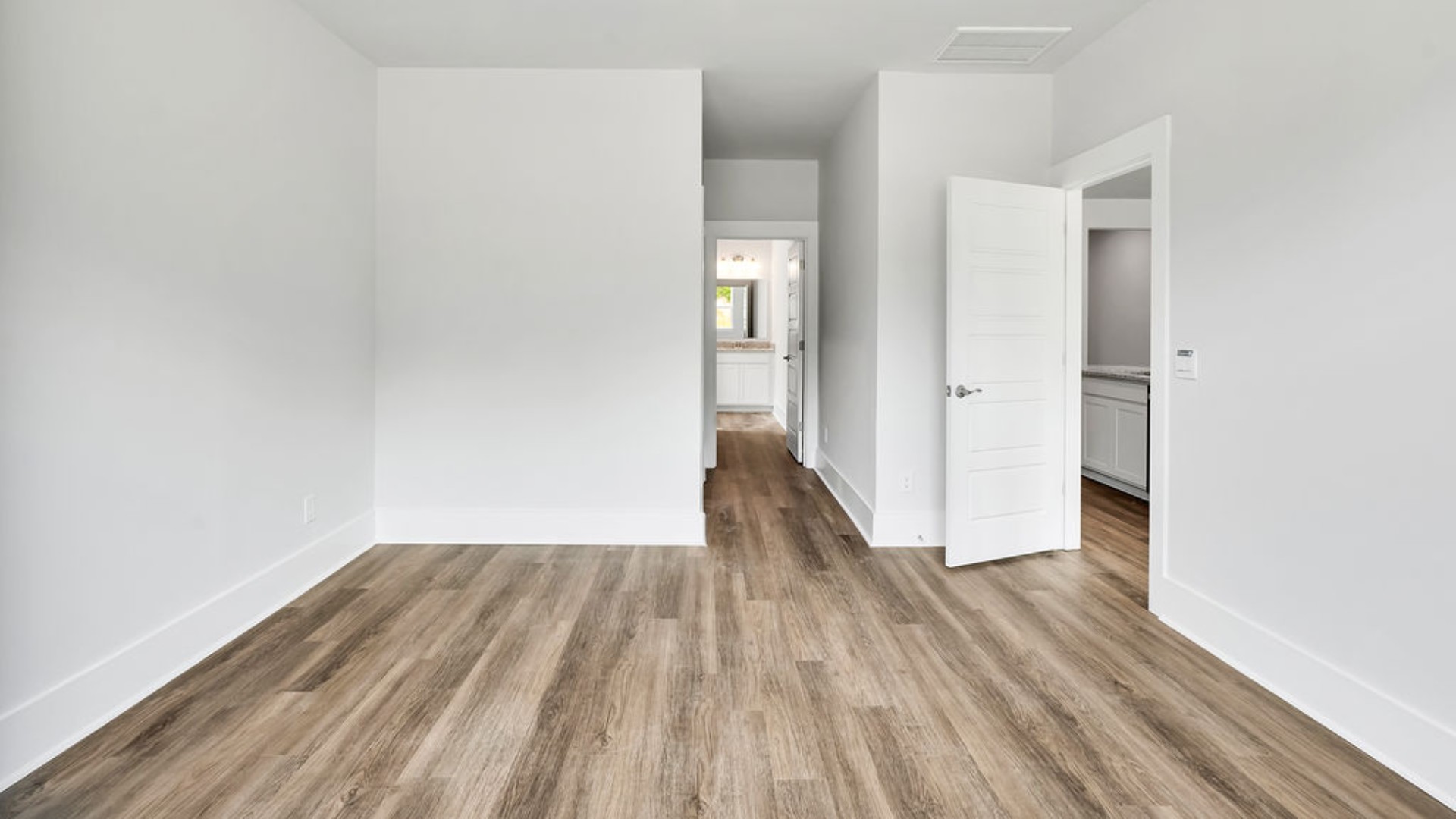 The primary suite is tucked away in the back corner of the home and allows homeowners the privacy to relax and unwind. The primary bedroom boasts a walk-in closet, dual vanity, and separate soaking tub and walk-in shower.