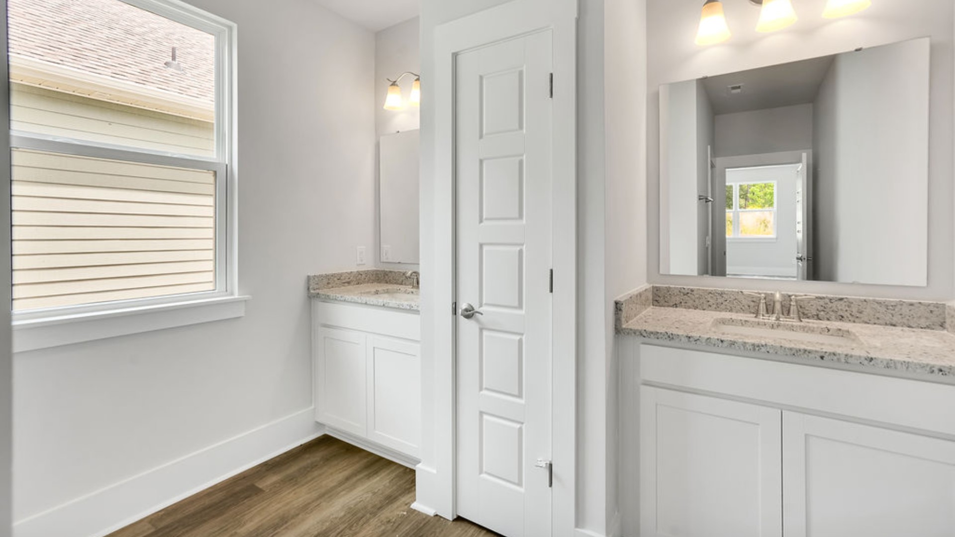 The primary suite is tucked away in the back corner of the home and allows homeowners the privacy to relax and unwind. The primary bedroom boasts a walk-in closet, dual vanity, and separate soaking tub and walk-in shower.