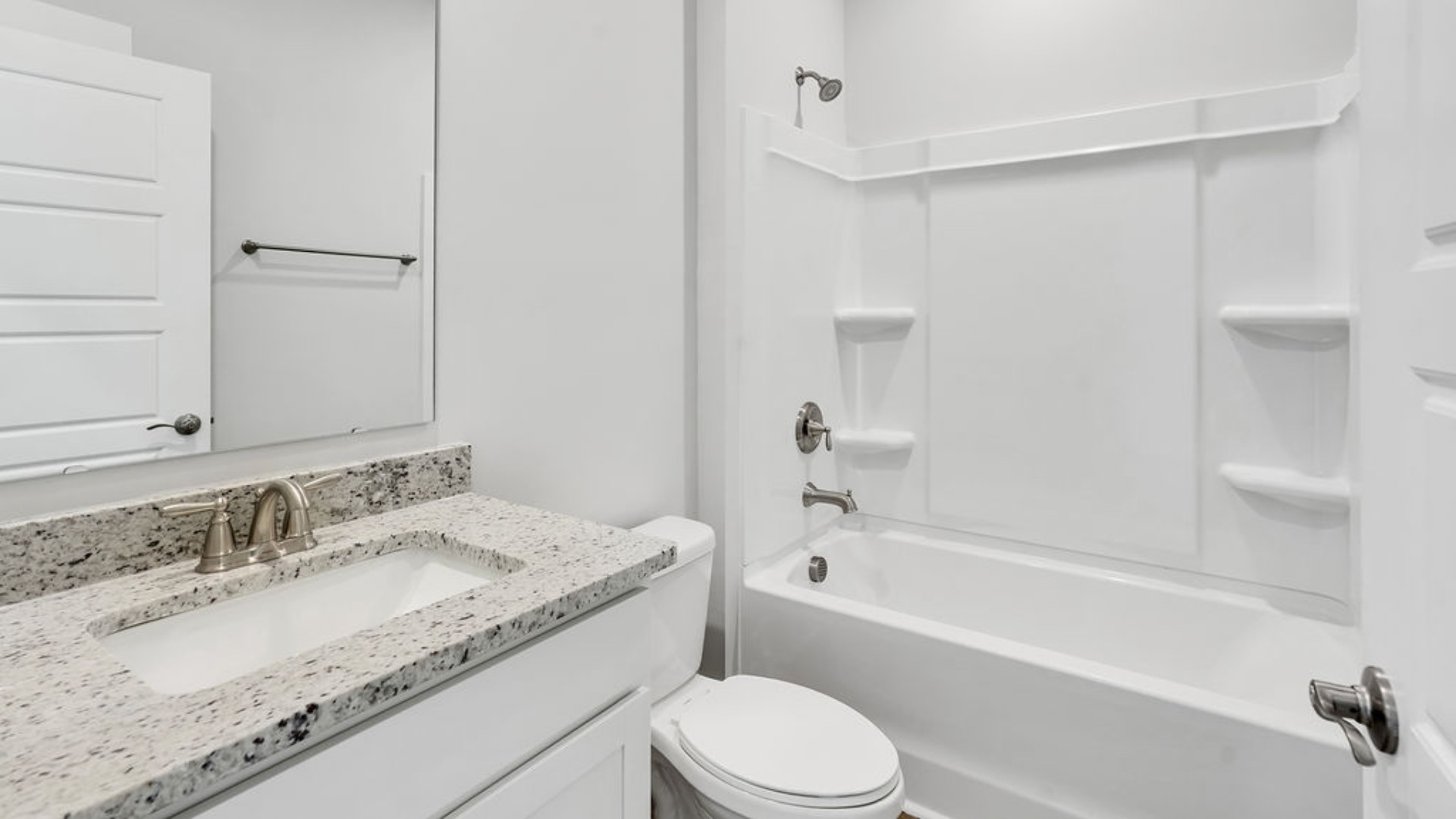 As you make your way off the front porch, a foyer leads you into the heart of the home. Two bedrooms sit off the main foyer and share a full bathroom in the middle.
