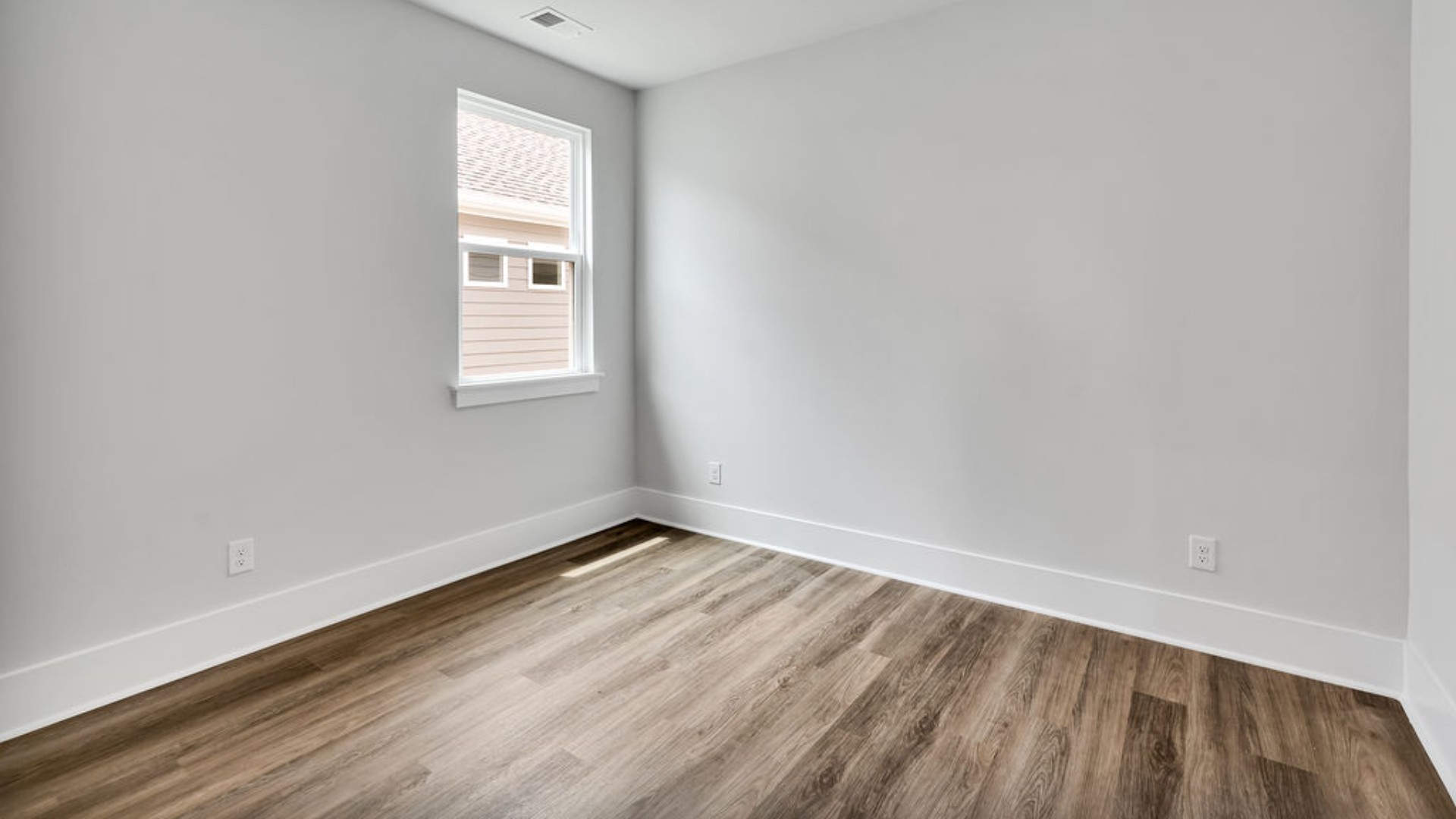 As you make your way off the front porch, a foyer leads you into the heart of the home. Two bedrooms sit off the main foyer and share a full bathroom in the middle.