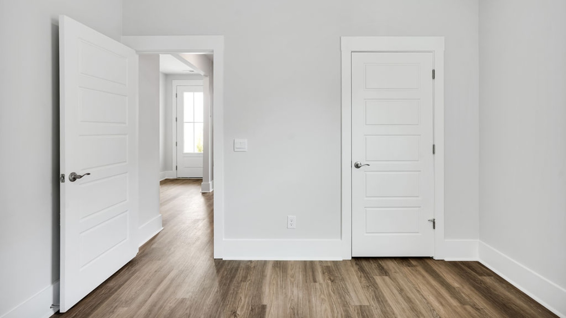 As you make your way off the front porch, a foyer leads you into the heart of the home. Two bedrooms sit off the main foyer and share a full bathroom in the middle.