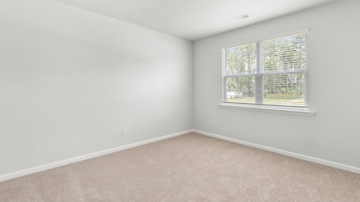 As you make your way off the front porch, a foyer leads you into the heart of the home. Two bedrooms sit off the main foyer and share a full bathroom in the middle.