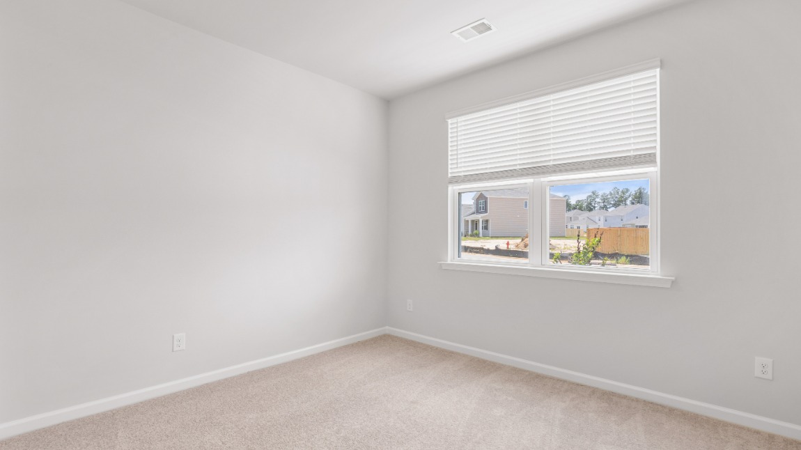 As you make your way off the front porch, a foyer leads you into the heart of the home. Two bedrooms sit off the main foyer and share a full bathroom in the middle.