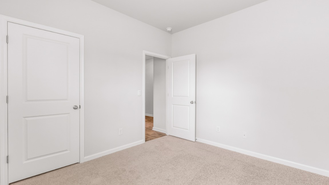 As you make your way off the front porch, a foyer leads you into the heart of the home. Two bedrooms sit off the main foyer and share a full bathroom in the middle.