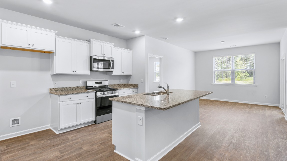 The main living area does not disappoint, by offering plenty of room to gather with family and friends. The kitchen includes a walk-in pantry, stainless-steel appliances, and a large island for bar seating.