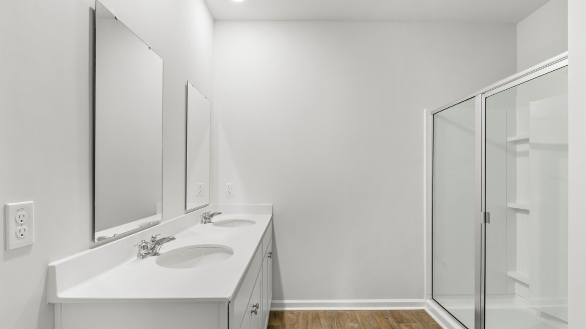 The primary suite includes a walk-in-closet and ensuite bath with a double vanity, walk-in-shower, and separate water closet.