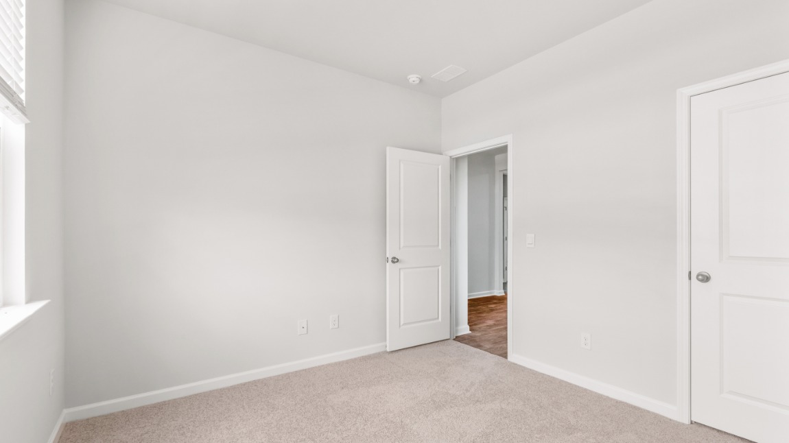 Two bedrooms sit off the main foyer and share a full bathroom in the middle. The laundry room is situated at the end of the front hallway right outside of the two-car garage entrance into the home.