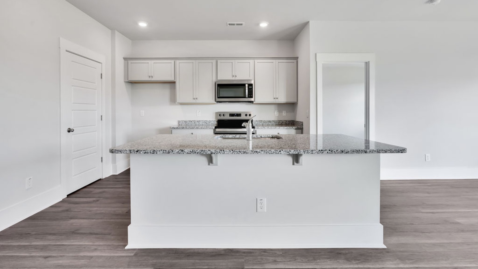 The main living area does not disappoint, by offering plenty of room to gather with family and friends in front of the corner fireplace. The updated kitchen includes a walk-in pantry, stainless-steel appliances, and a large island for bar seating.