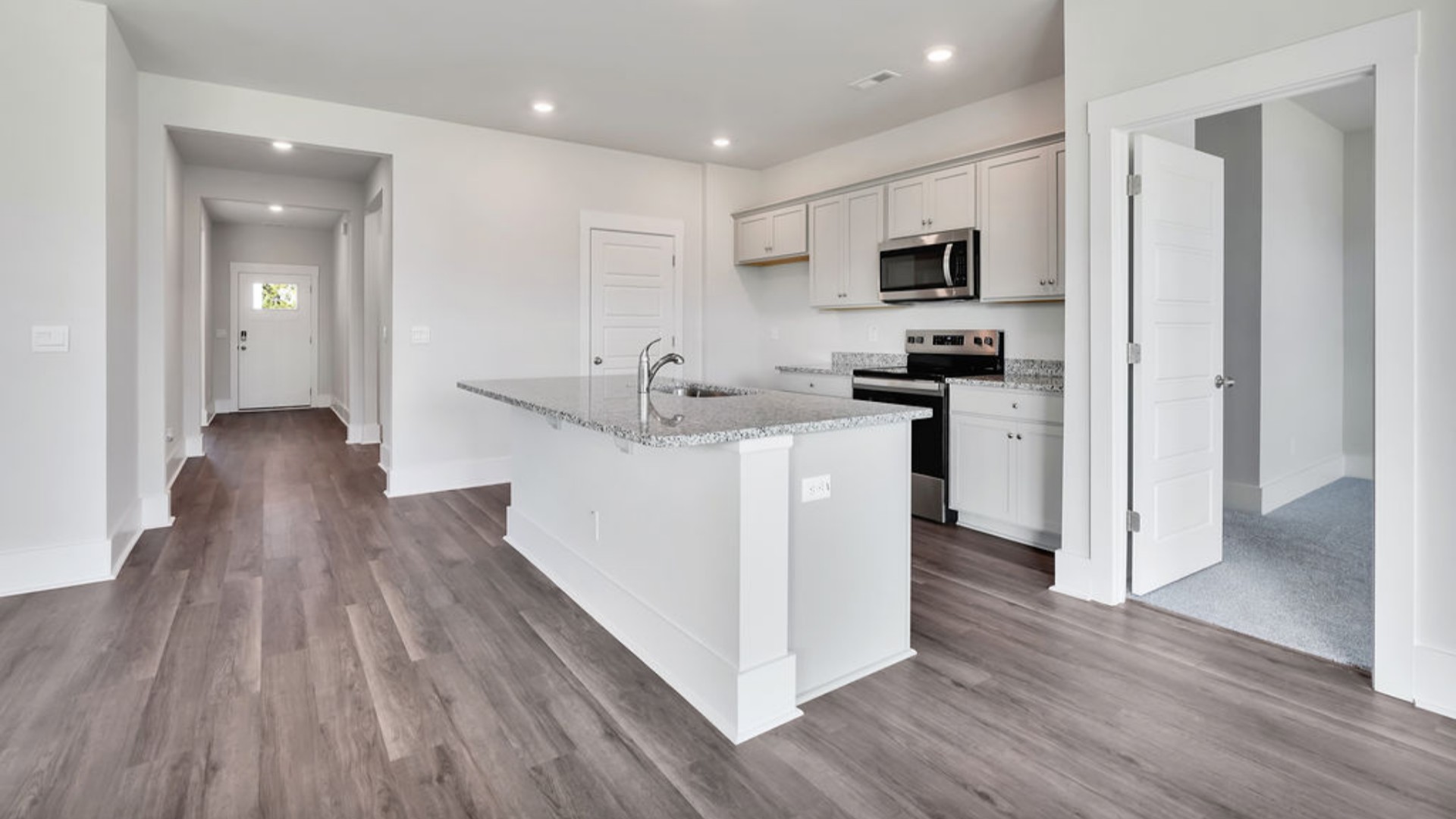 The main living area does not disappoint, by offering plenty of room to gather with family and friends in front of the corner fireplace. The updated kitchen includes a walk-in pantry, stainless-steel appliances, and a large island for bar seating.