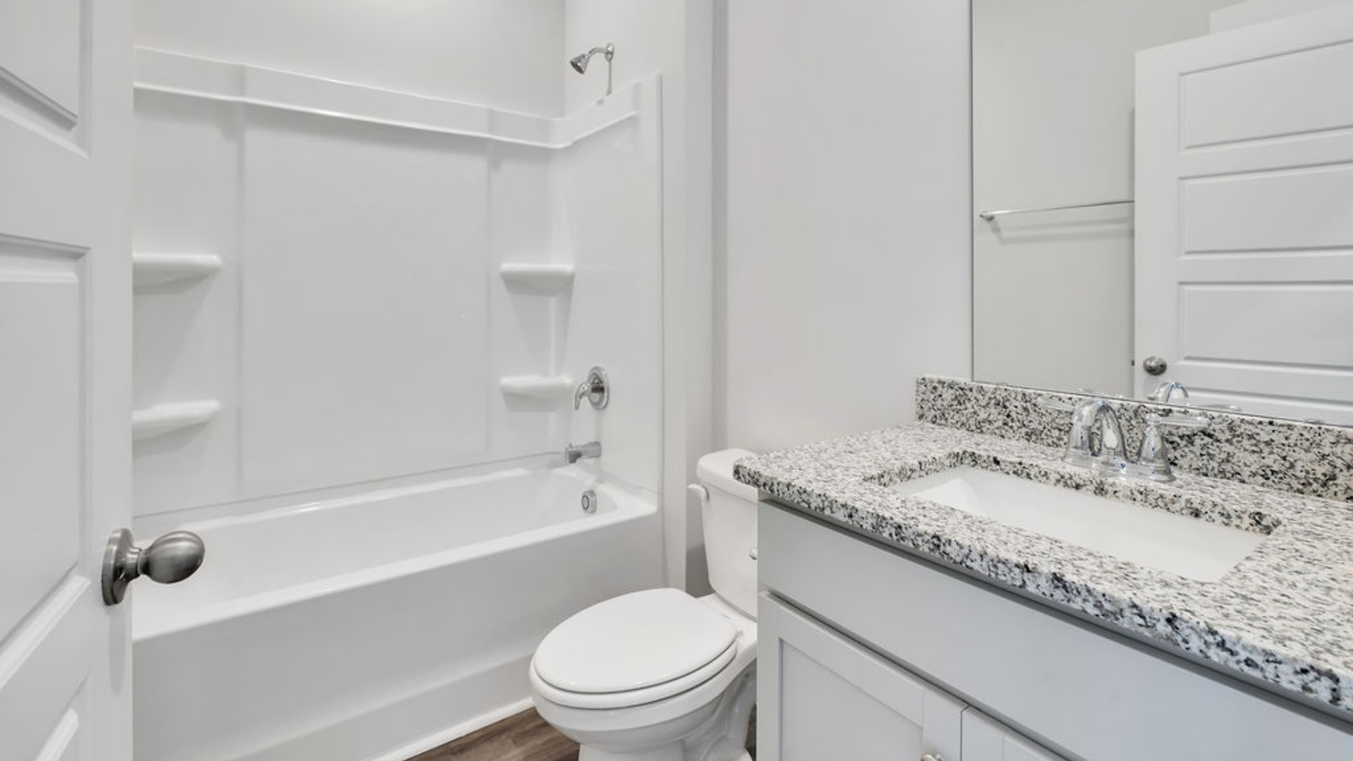 As you make your way off the front porch, a foyer leads you into the heart of the home. Two bedrooms sit off the main foyer and share a full bathroom in the middle.