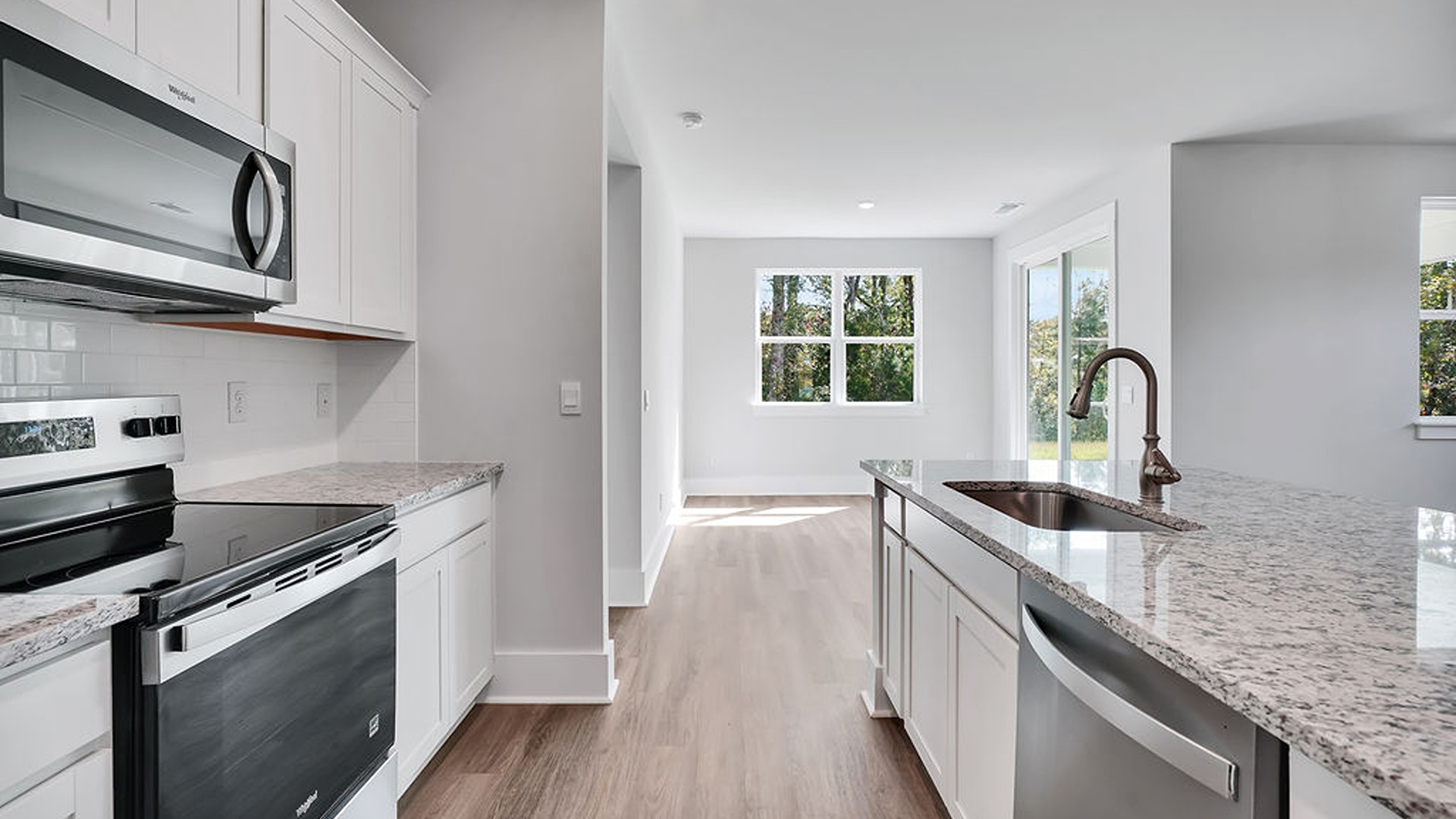 The kitchen comes finished with beautiful granite countertops, stainless steel appliances, single-bowl sink and tile backsplash. You'll never be too far from the action with the living and dining area right there.