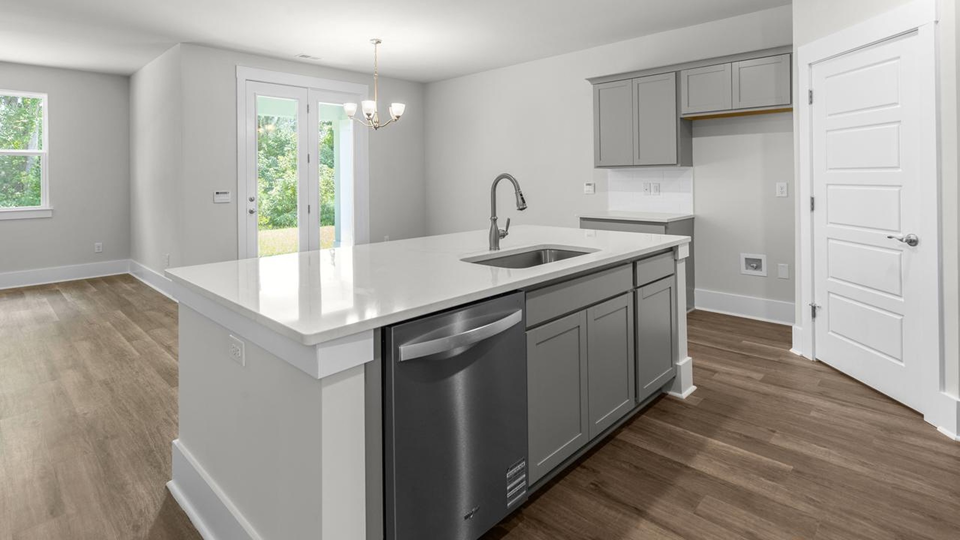 The well-appointed kitchen is equipped with modern appliances, walk-in pantry, and center island, perfect for both cooking and casual dining.
