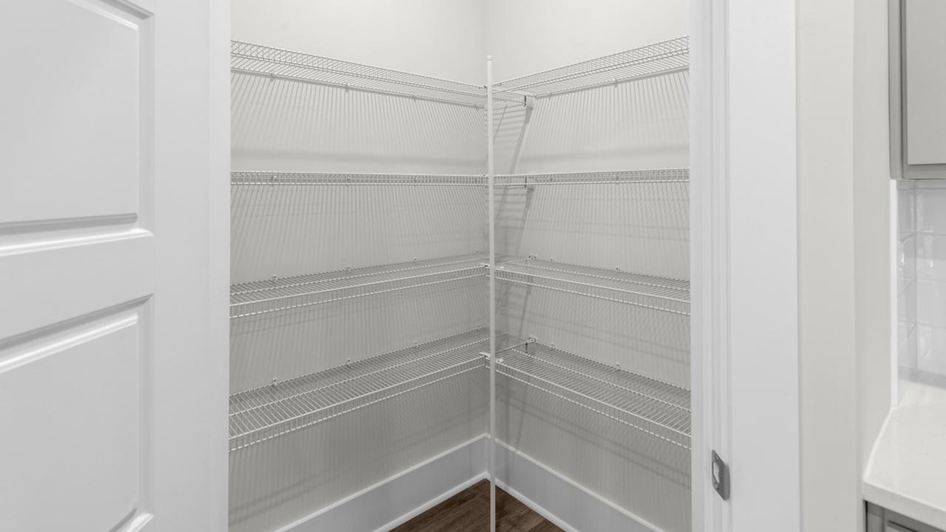 The well-appointed kitchen is equipped with modern appliances, walk-in pantry, and center island, perfect for both cooking and casual dining.