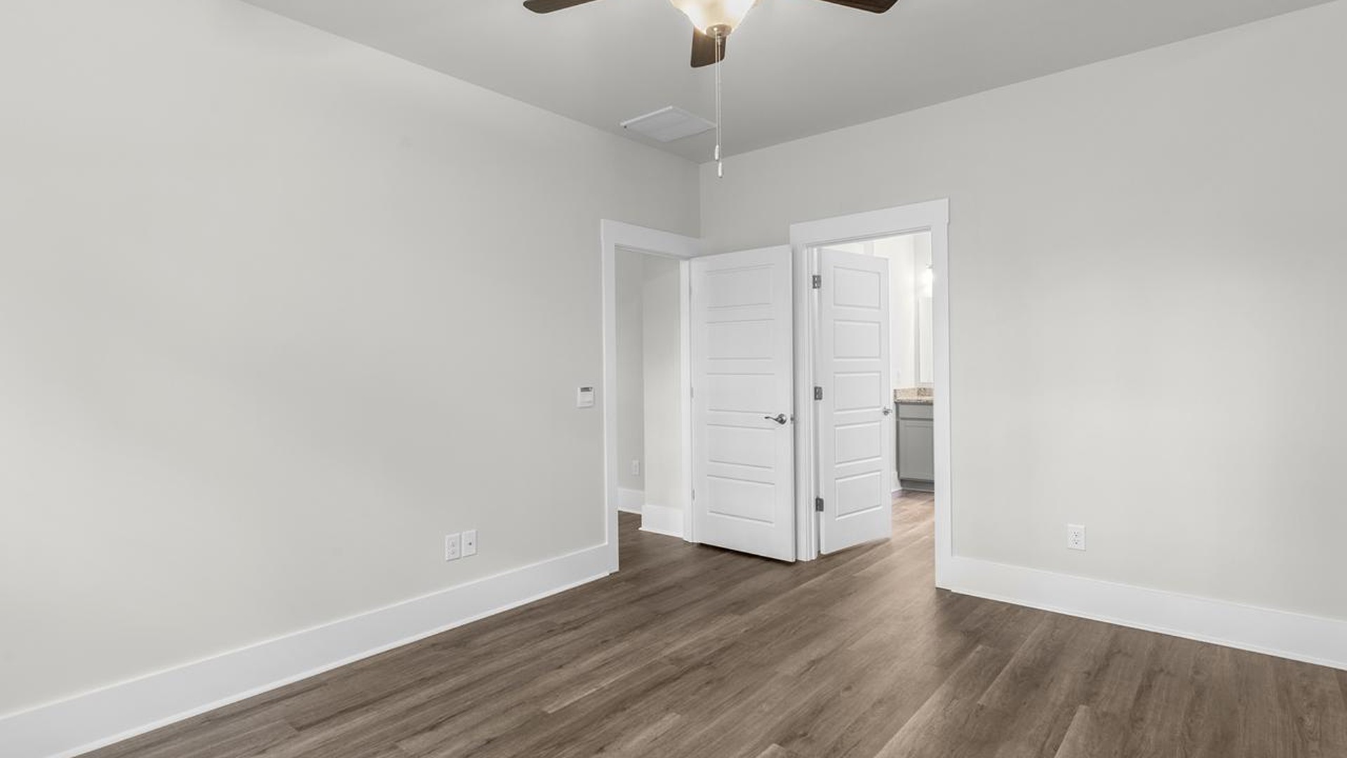 The primary suite serves as a peaceful retreat, featuring an en-suite bathroom with dual vanities and a walk-in closet. The additional bedrooms provide comfort and privacy and share access to a secondary bathroom.