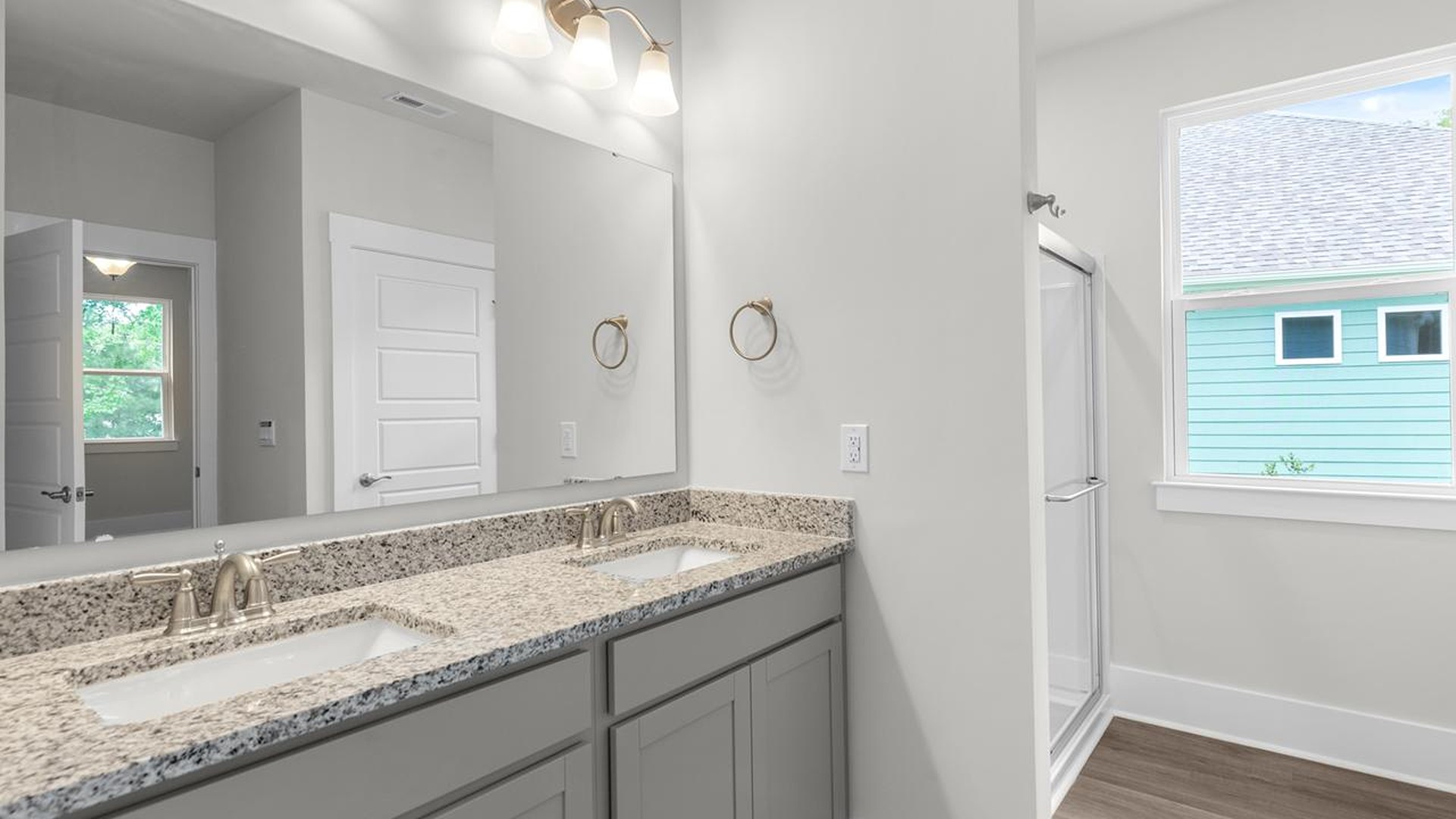 The primary suite serves as a peaceful retreat, featuring an en-suite bathroom with dual vanities and a walk-in closet. The additional bedrooms provide comfort and privacy and share access to a secondary bathroom.
